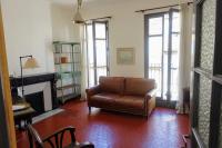 a living room with a couch and a fireplace at Tout le charme de l&#39;ancien marseillais in Marseille