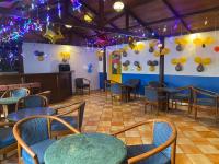 a dining room with tables and chairs and lights at Hotel Kant Palace in Tājganj
