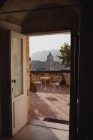 an open door to a patio with a table and chairs at Sant&#39;Angelo, Matera - Small Luxury Hotels in Matera