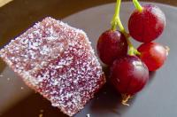 a plate with a piece of cake and three cherries at Auberge Les Grillons in Meyras