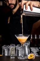 a man pouring a drink into a martini glass at Hotel Valkenburg by Mercure - Next to Shimano Experience Center in Valkenburg