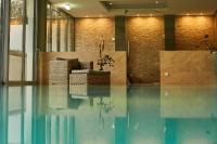 a lobby with a couch sitting on top of a pool at Fuchsbau Romantik Hotel & SPA Restaurant & FOX Bar in Timmendorfer Strand