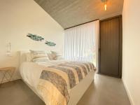 Postel nebo postele na pokoji v ubytování La Casa de Hierba - Casa de campo de diseño con jardín y wifi cerca de las playas de Llanes