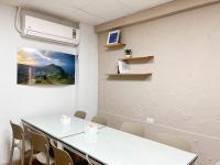 a meeting room with a white table and chairs at Cen Pin B&amp;B in Jiufen