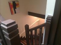 a set of stairs with a painting on the wall at Hotel Restaurant Tokyo in Trouville-sur-Mer