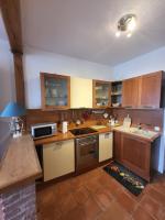 a kitchen with wooden cabinets and a stove top oven at Quai Babord in Fécamp