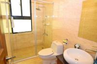 a bathroom with a shower and a toilet and a sink at Lu Fang View in Donggang