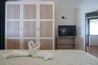 Televízia a/alebo spoločenská miestnosť v ubytovaní Il Poggio Di Tropea