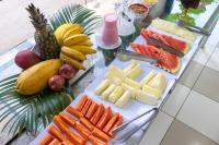a table with a bunch of fruit and vegetables on it at Pousada Boulevard in Cabo Frio