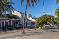 a street in a town with palm trees and buildings at Pousada Boulevard in Cabo Frio