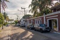 a street with cars parked on the side of a building at Pousada Boulevard in Cabo Frio