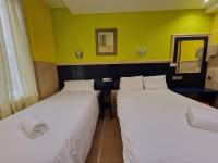 A bed or beds in a room at Pension Izar Bat Guesthouse