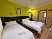 A bed or beds in a room at Pension Izar Bat Guesthouse