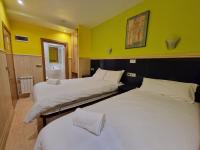 A bed or beds in a room at Pension Izar Bat Guesthouse