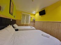 A bed or beds in a room at Pension Izar Bat Guesthouse