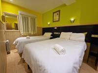 A bed or beds in a room at Pension Izar Bat Guesthouse
