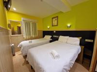 A bed or beds in a room at Pension Izar Bat Guesthouse