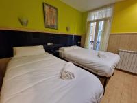 A bed or beds in a room at Pension Izar Bat Guesthouse