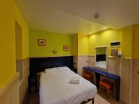 A bed or beds in a room at Pension Izar Bat Guesthouse