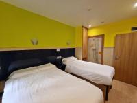 A bed or beds in a room at Pension Izar Bat Guesthouse