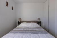 a bed in a bedroom with two lamps on tables at LaConciergerieJonzac, Appartement La Désirade in Jonzac