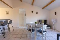 a kitchen and dining room with a table and chairs at LaConciergerieJonzac, Appartement La Désirade in Jonzac