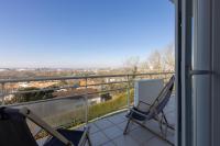 a balcony with chairs and a view of a city at LaConciergerieJonzac, Appartement La Désirade in Jonzac