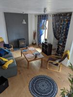 a living room with a couch and a table at Maison de quartier populaire. in Aubusson