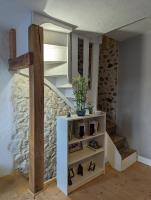 a room with a staircase and a shelf with shoes at Maison de quartier populaire. in Aubusson