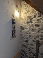 a room with a stone wall with a light on it at Maison de quartier populaire. in Aubusson