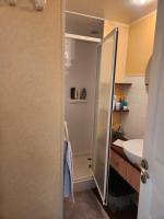 a bathroom with a shower and a sink at Mobil home 6 personnes Forêt des landes in Mimizan