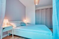 a blue bedroom with a bed and a desk at Le 002 - T3 climatisé avec terrasse in Marseille