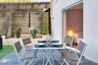 a dining table and chairs in a patio area with at Le 002 - T3 climatisé avec terrasse in Marseille