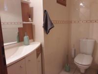 a bathroom with a toilet and a sink and a mirror at Belle de Dune in La Baule