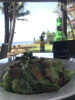 een bord eten op een tafel met een fles bier bij Spacious Private Pool Apartment-Beachside Resort in Candidasa