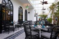 a restaurant with tables and chairs on a patio at Hoi An Delicacy Hotel & Spa in Hoi An
