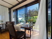 a dining room with a table and a large window at Landgasthof Seelust in Egnach