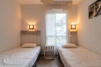 Łóżko lub łóżka w pokoju w obiekcie L'Arvor - Appt piscine et sauna partagés