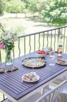 a picnic table with plates of food and glasses of wine at Domaine De Sigalous in La Crau