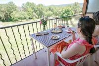 a little girl sitting at a table on a balcony at Domaine De Sigalous in La Crau