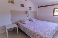 a bedroom with a bed and a table and a window at Domaine De Sigalous in La Crau