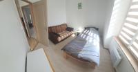 a small bedroom with a bed and a chair at Cramiland - Super appart 5 pers centre ville in Montbéliard
