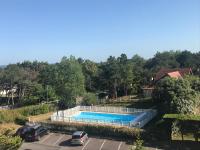 an overhead view of a swimming pool in a parking lot at Le petit coin de Paradis in Varaville