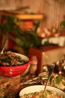 a table with plates of food and a red bowl at Alaya Poleg in Netanya