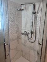 a shower in a bathroom with a glass door at Maison Climatisée 04 chambres Paris Disney CDG in Gagny