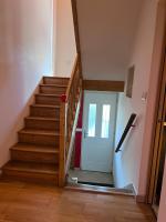 a staircase with a white door in a room at Maison Climatisée 04 chambres Paris Disney CDG in Gagny