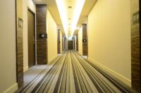 an empty hallway in a building with wood floors at Chateau-Rich Hotel in Tainan