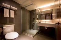 a bathroom with a toilet and a shower and a sink at Chateau-Rich Hotel in Tainan