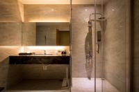 a bathroom with a shower and a sink at Chateau-Rich Hotel in Tainan