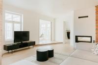 a white living room with a tv and a couch at Luxury 2BR Apartment in Haapsalu Old Town in Haapsalu